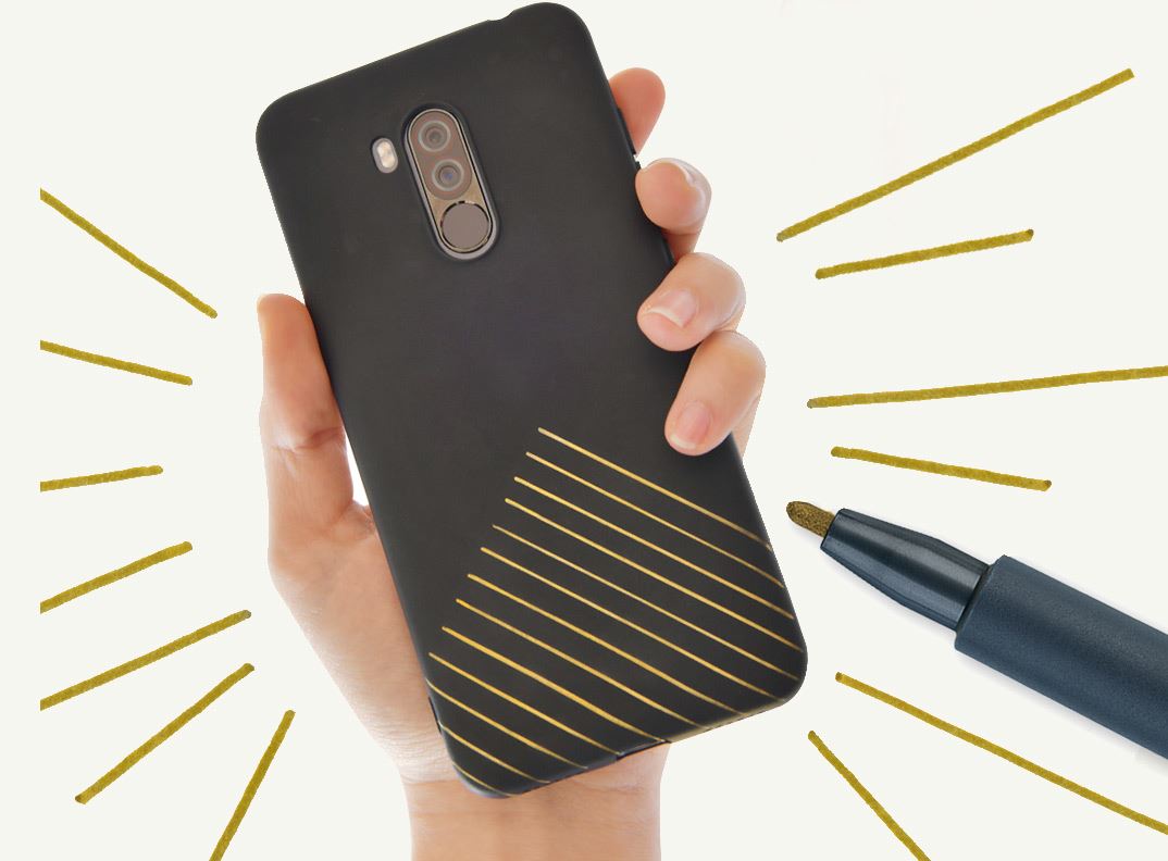 A black smartphone case with golden embellishements is holden up.